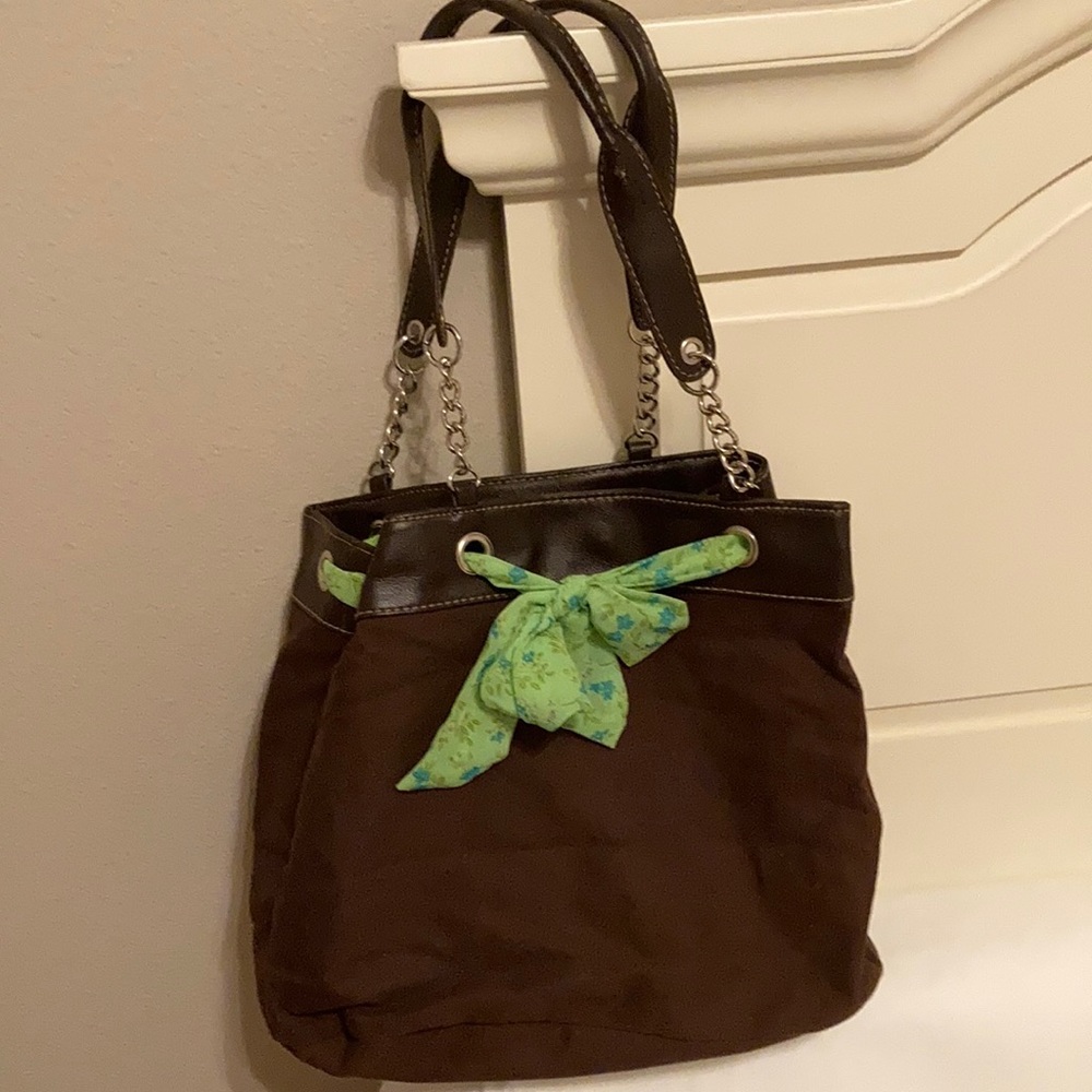 Brown bag with green tie. Includes wallet.